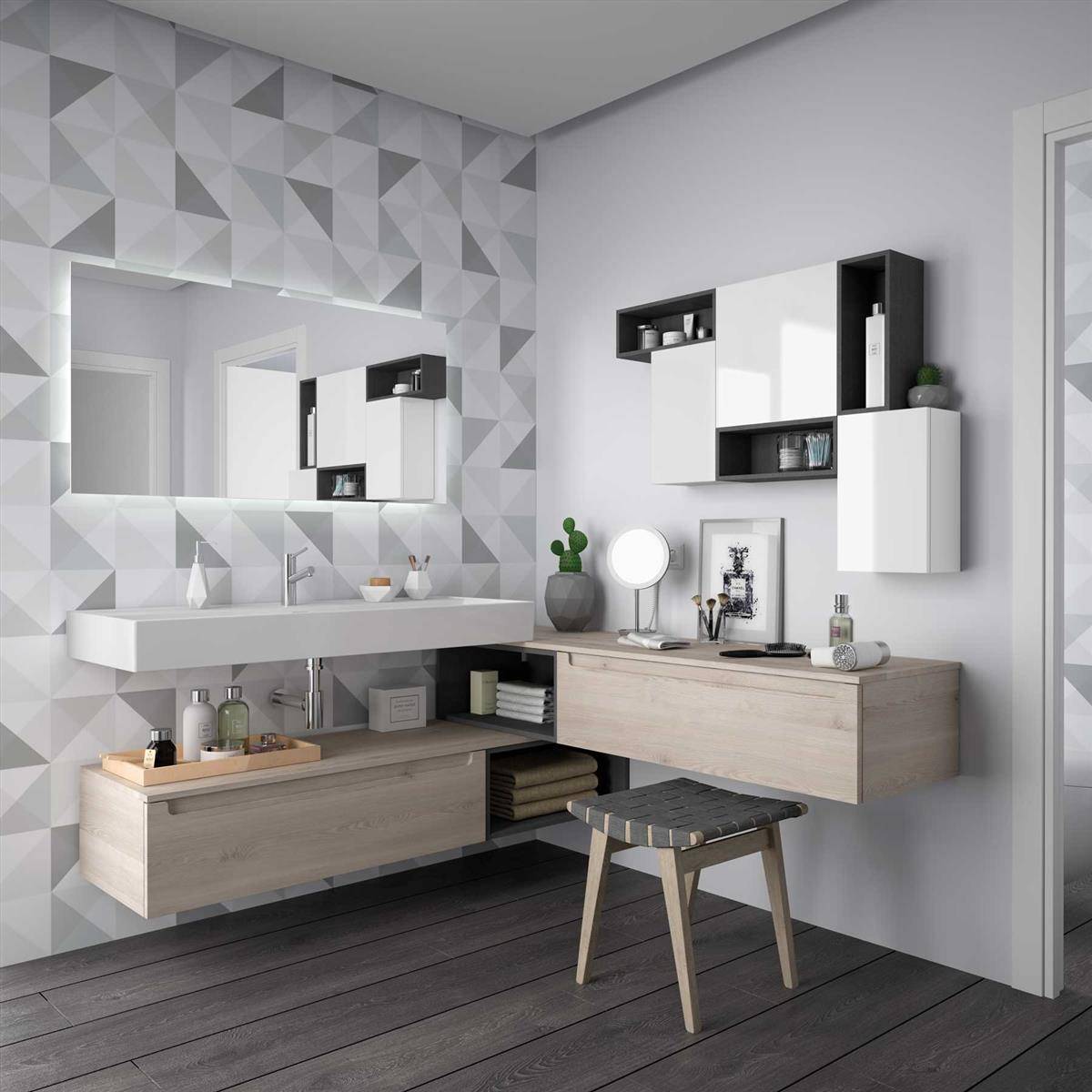 Modernes Badezimmermöbel mit wandmontiertem Waschbecken, großem Spiegel, schwebendem Schrank und hölzerner Bank in einem Raum mit grauem geometrischem Fliesenmuster.
