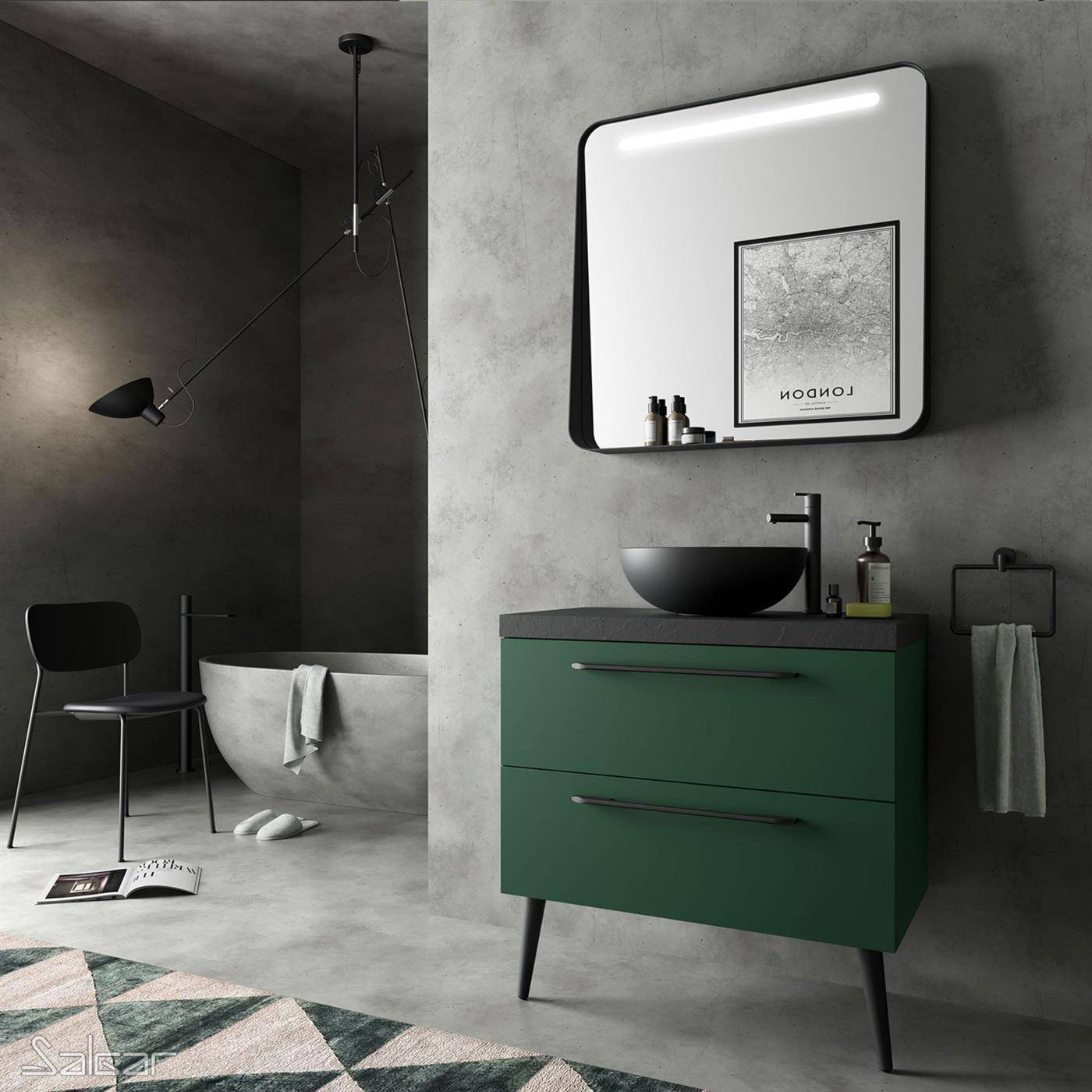 Modernes Badezimmer mit grüner Waschtischanlage und rundem schwarzem Waschbecken unter einem Spiegel, neben einem schwarzen Stuhl und einer freistehenden Wanne in einem minimalistischen grauen Raum.