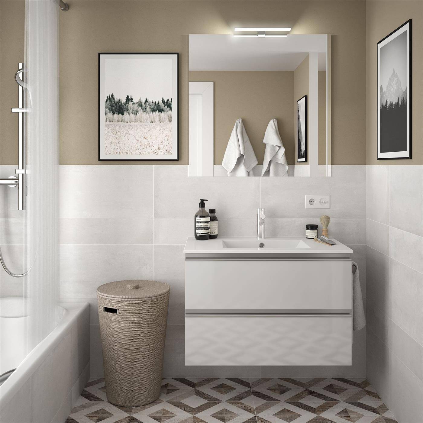Modernes Badezimmer mit Badewanne, wandmontiertem Waschbecken und Spiegel, gerahmter Kunst, gewebtem Wäschekorb und gemustertem Fliesenboden.