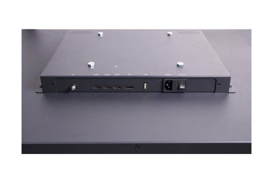 Schwarze Metallelektronikeinheit von vorne betrachtet, die vier kleine Anschlüsse, einen USB-Anschluss, einen Stromeingang und einen Netzschalter auf einer flachen grauen Oberfläche zeigt.