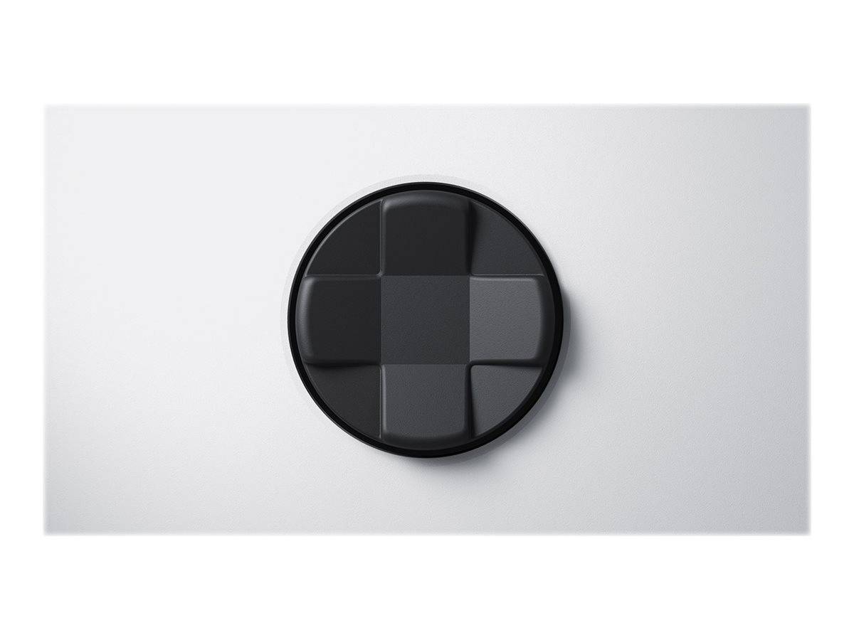 Schwarzes kreisförmiges 3D-Symbol mit einem erhobenen vierseitigen Richtungskreuz, zentriert auf einem hellgrauen Hintergrund.