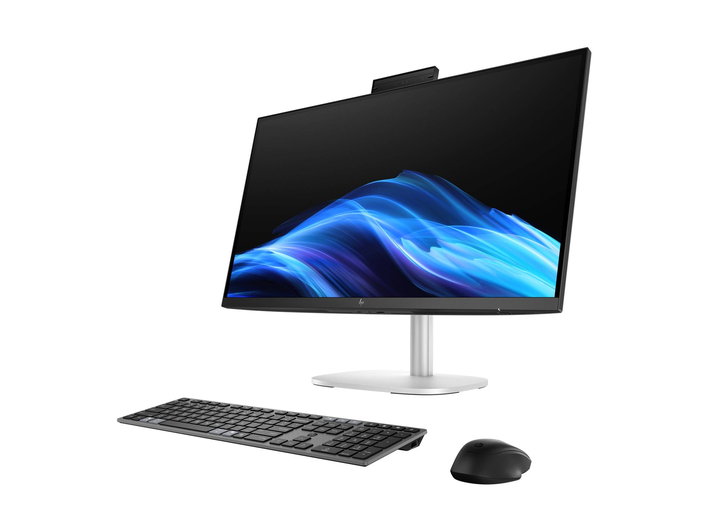 Ein schlankes, modernes Desktop-Computer-Setup mit einem dünnen Monitor, der eine blaue abstrakte Welle zeigt. Ausgestattet mit einer drahtlosen Tastatur und Maus.