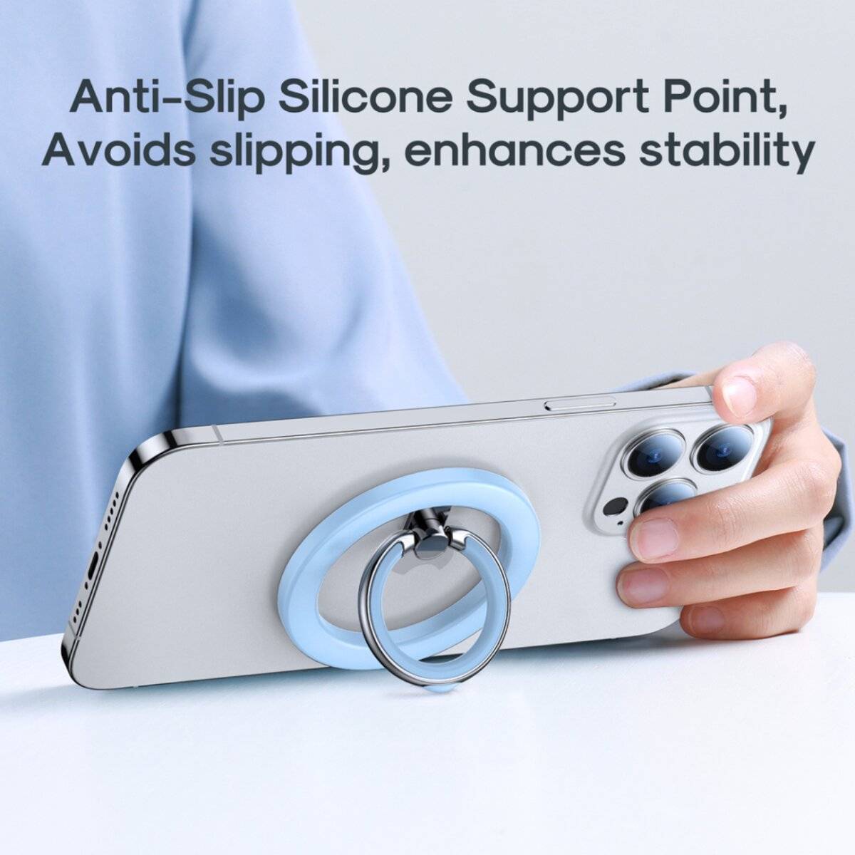 Eine Hand hält ein Smartphone mit einem Ringhalter und einer blauen rutschfesten Silikon-Unterstützung, mit dem Text: 