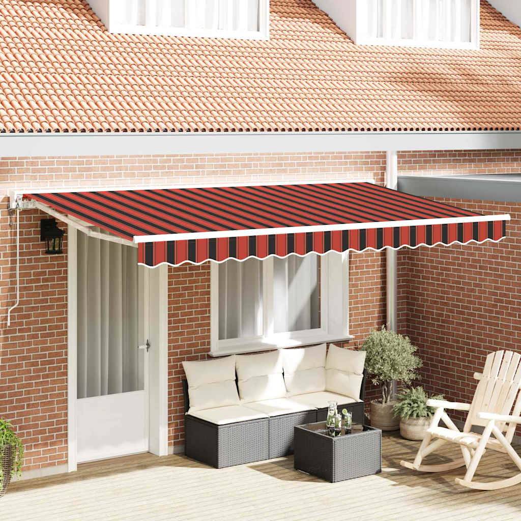 Ein rot und schwarz gestreifter ausziehbarer Markise bedeckt eine Terrasse mit weißen Türen, einem beigen Sofa, Pflanzen und hölzernen Stühlen unter einem Ziegeldach.