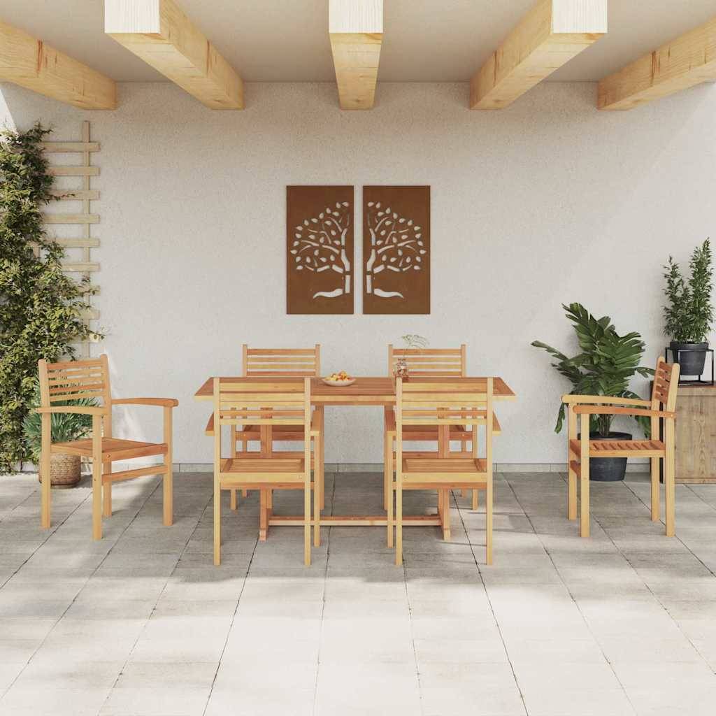Terrassenbereich mit einem Holz-Esstisch unter einer Pergola. Zwei Baumkunstwerke hängen an der Wand. Topfpflanzen dekorieren den Raum.