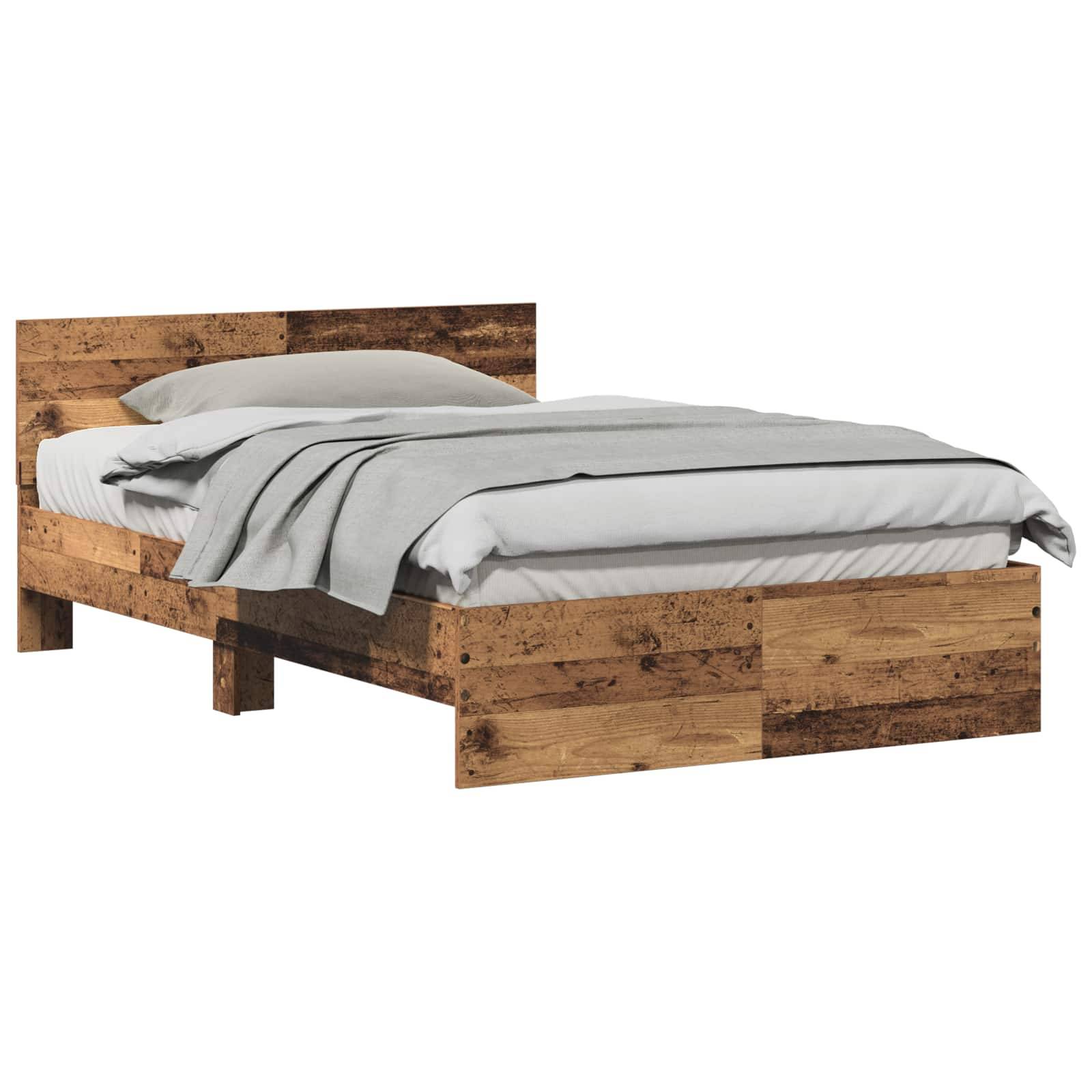 Ein Holzbettgestell mit Kopfteil, auf dem ein ordentlich gemachtes Bett mit weißen Betttüchern und einer grauen Decke drapiert ist.
