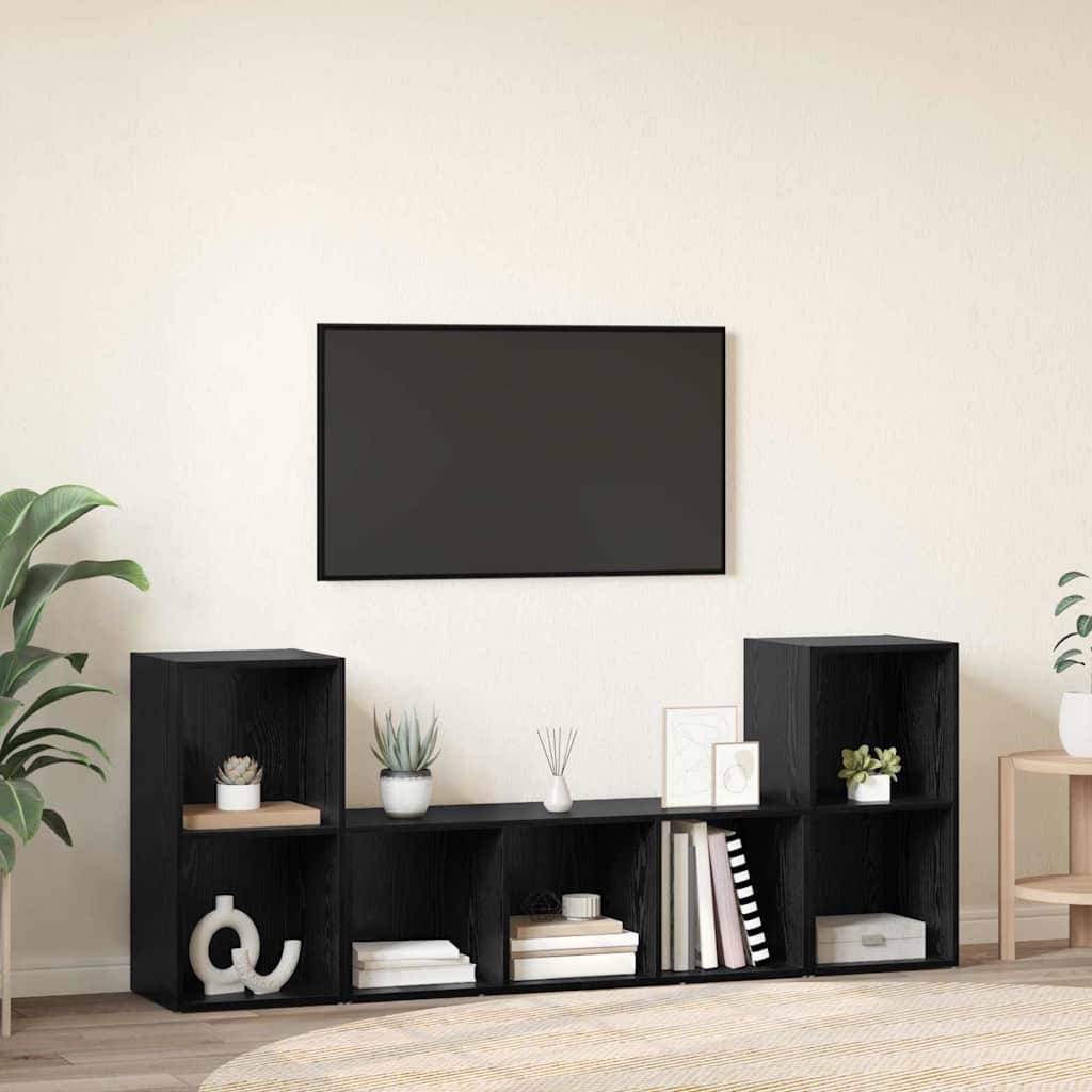 Ein modernes Wohnzimmer mit einem schwarzen Medienschrank, der Pflanzen und Bücher trägt, unter einem an der Wand montierten Fernseher.