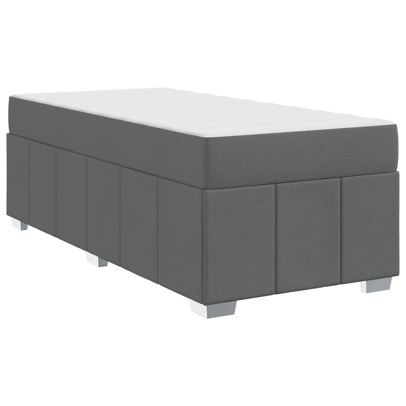 Graue gepolsterte Aufbewahrungsbank mit flacher Oberfläche und weißen Füßen, geeignet zum Sitzen oder Aufbewahren im Wohn- oder Schlafzimmer.