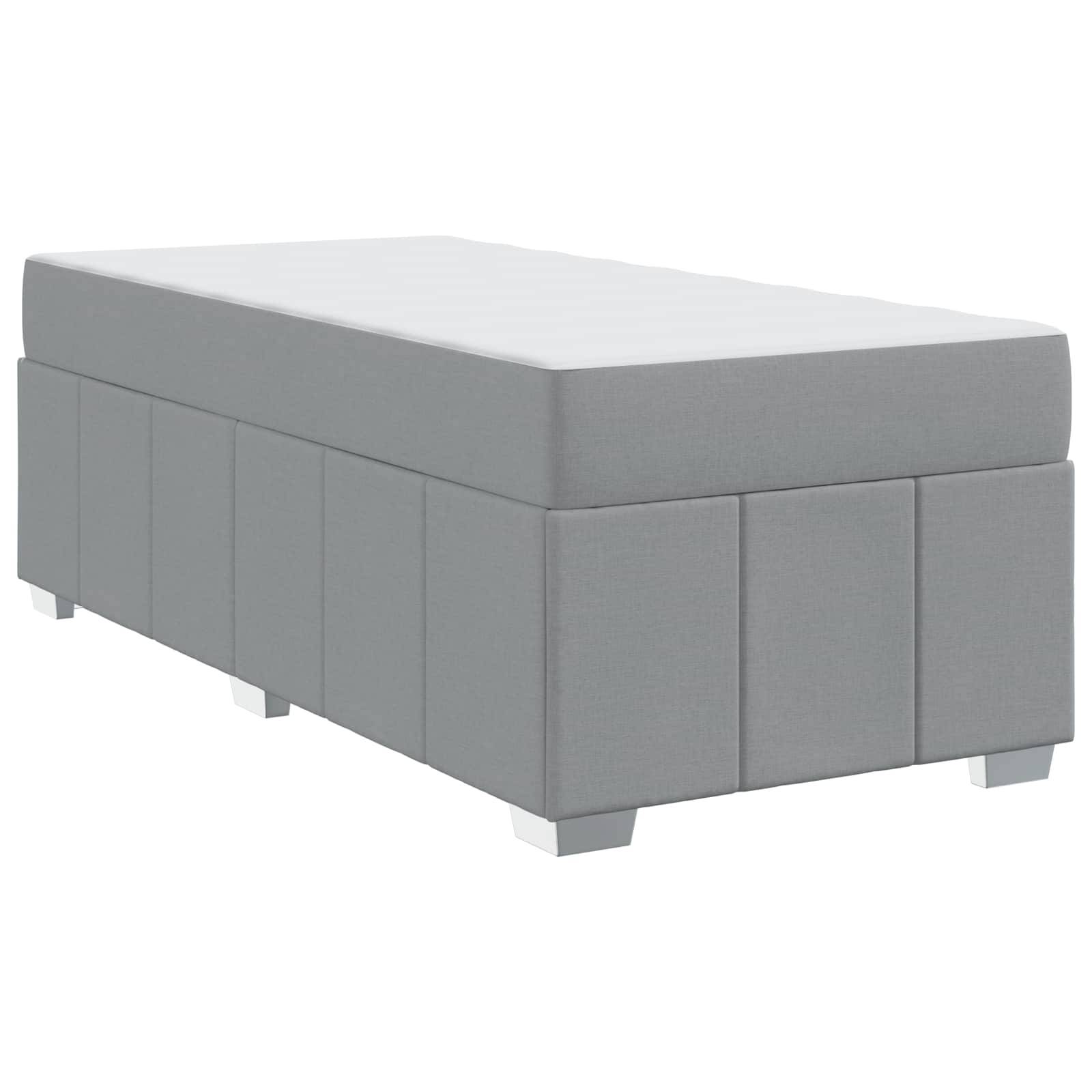 Grauer rechteckiger Polsterhocker mit weißer Oberfläche. Er verfügt über ein schlichtes, modernes Design mit kurzen Beinen und eignet sich für die Wohnzimmereinrichtung.