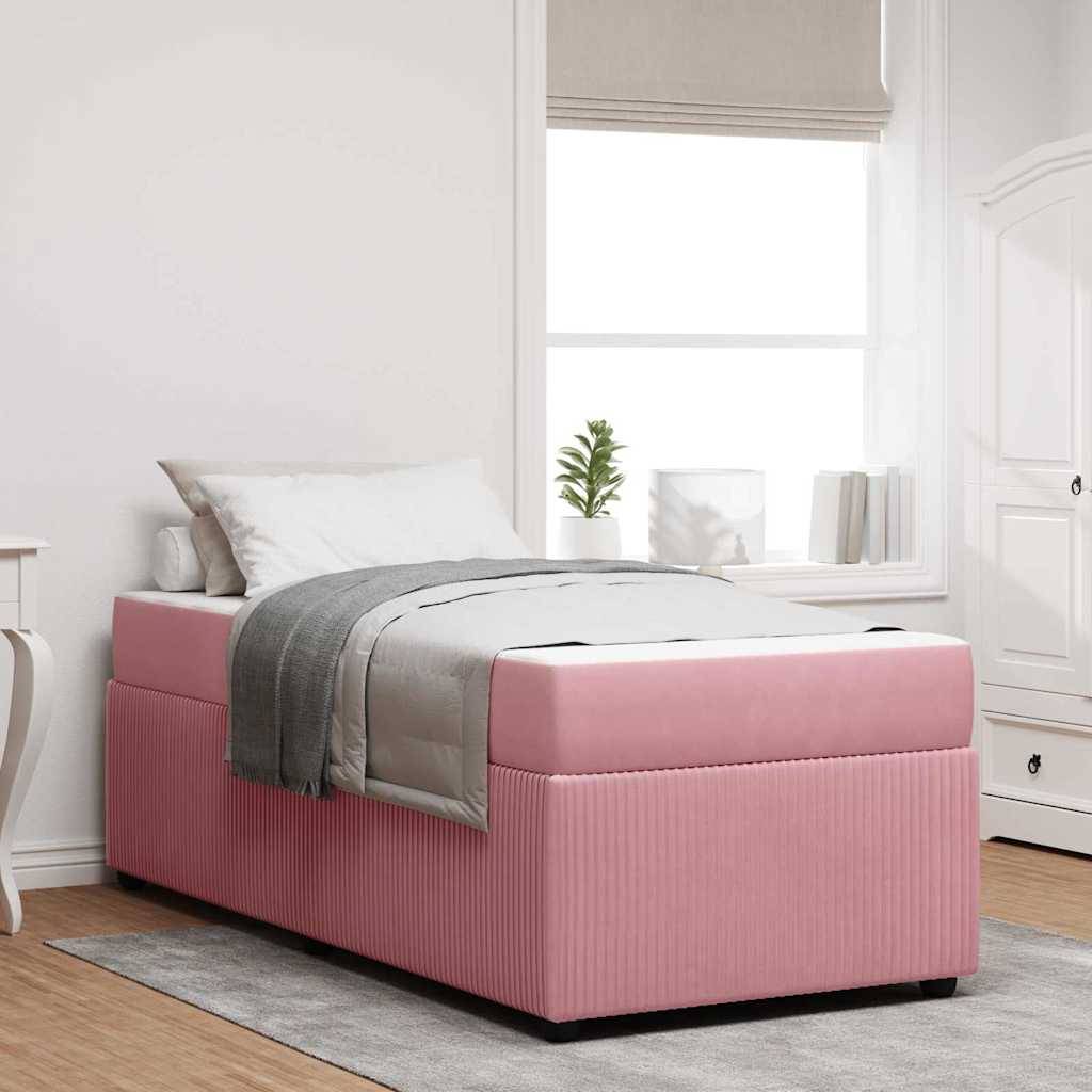 Einzelnes rosa gepolstertes Bett mit grauer Bettwäsche in einem hellen, minimalistischen Schlafzimmer neben einem Fenster und einem weißen Kleiderschrank.