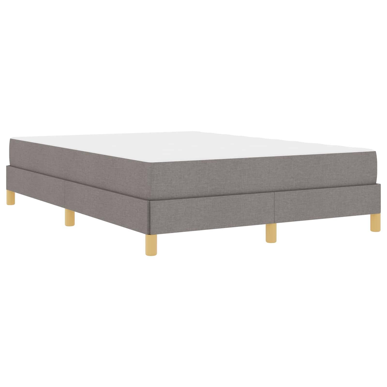 Ein graues gepolstertes Bett mit Holzbeinen, das ein minimalistisches und modernes Design aufweist.