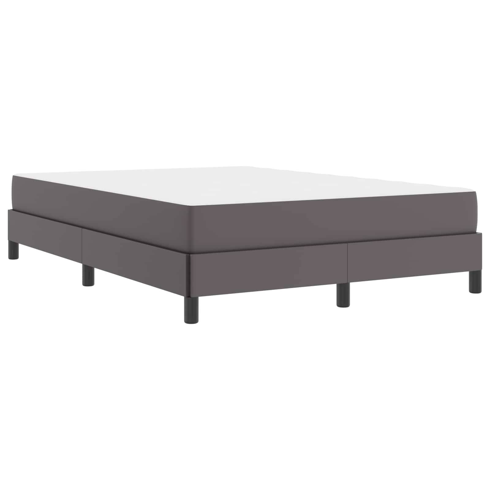 Ein minimalistischer Bettrahmen mit einer dunklen, rechteckigen Basis und zylindrischen Beinen. Das Bett hat ein schlichtes Design, das die Funktionalität in den Vordergrund stellt.