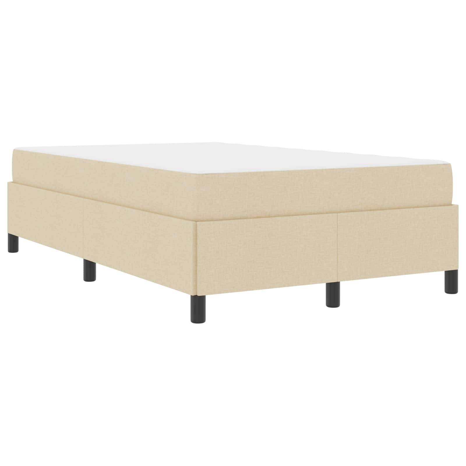 Beige gepolstertes Plattformbett mit schwarzen Beinen, von der Seite gesehen.