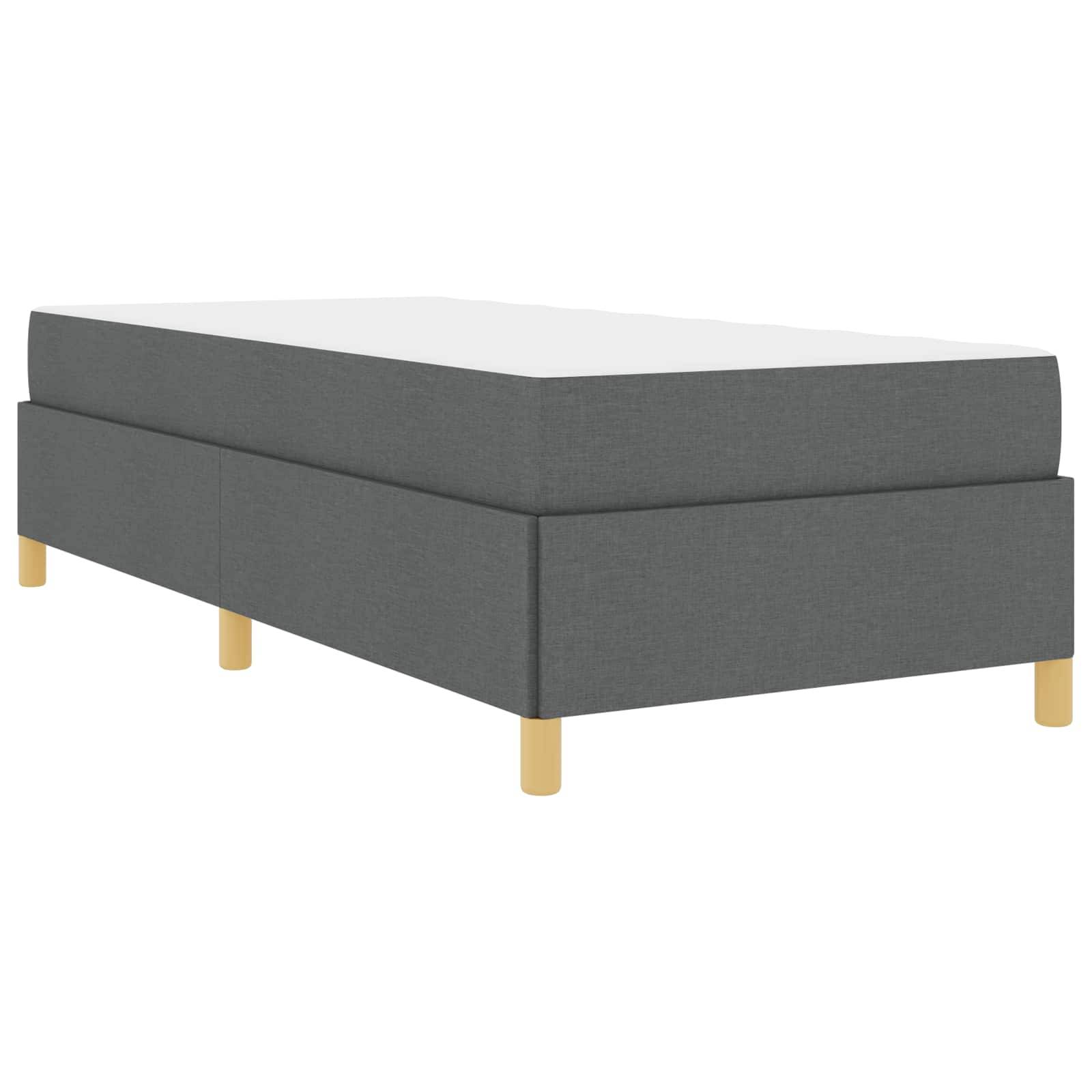 Ein grauer Bettrahmen mit Polsterung und Holzbeinen, im minimalistischen Stil dargestellt.