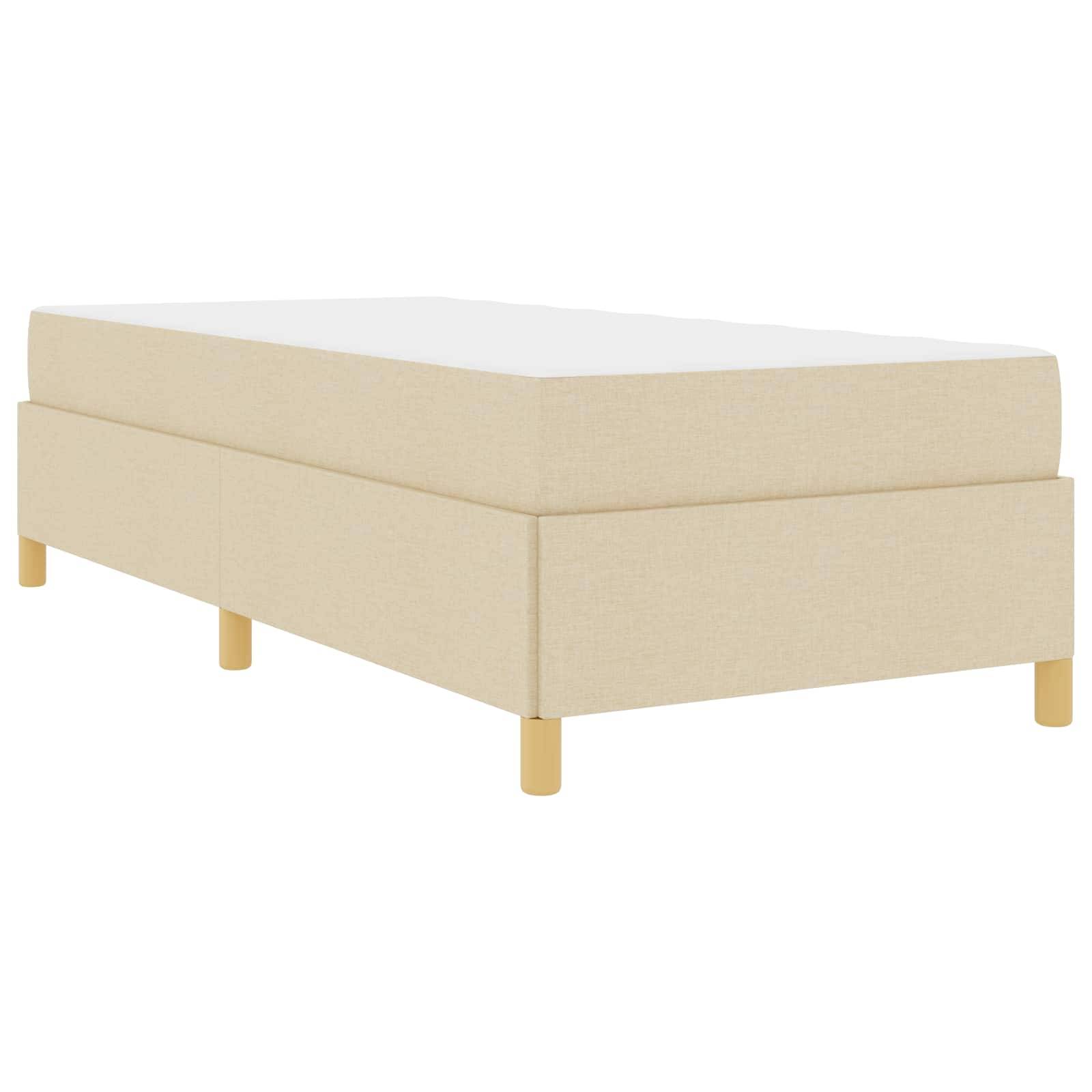 Ein beige, rechteckiges Bett mit schlichtem Design auf Holzbeinen. Das Bett verfügt über eine weiße Matratze und eine minimalistische Erscheinung.