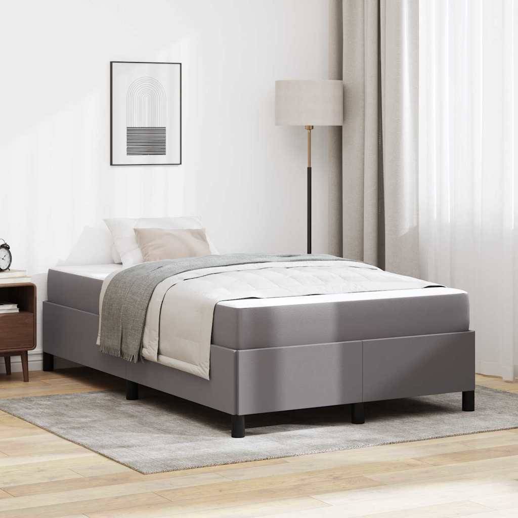 Modernes grau gepolstertes Bett mit weißer Bettwäsche in einem minimalistischen Schlafzimmer, neben einer Stehleuchte, Nachttisch, gerahmter Wandkunst und transparenten Vorhängen.