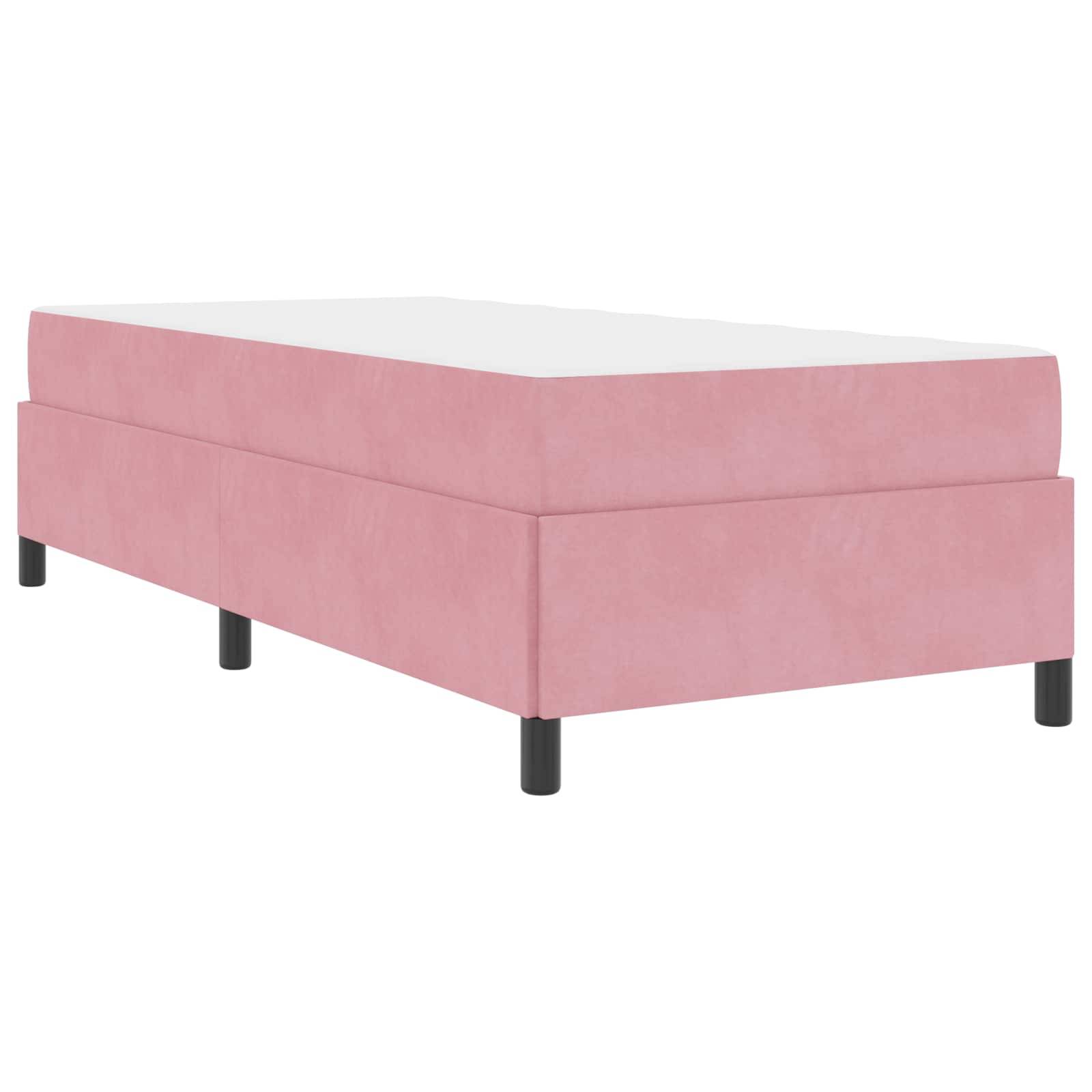 Ein rosa, rechteckiges Einzelbett mit einer weißen Matratze und vier schwarzen Beinen, von einem Winkel aus betrachtet.
