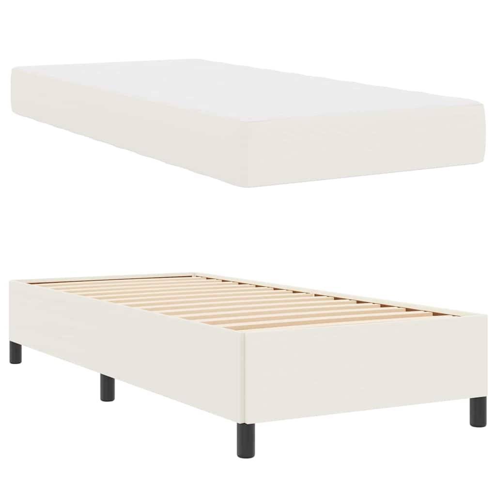 Eine weiße Matratze und ein separater weißer Bettrahmen mit Holzlatten und schwarzen Beinen sind ausgestellt.
