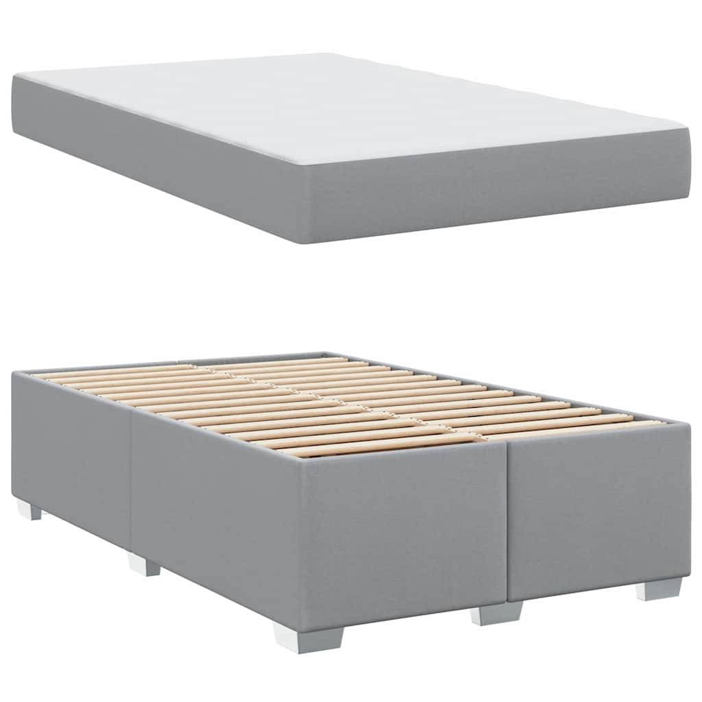 Ein grauer Plattformbettrahmen mit einem flachen Profil, ausgestattet mit Holzlamellen zur Unterstützung und einer schlichten, modernen Ästhetik.