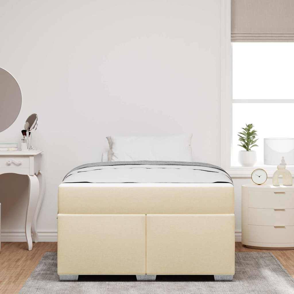 Ein sorgfältig gemachtes Bett mit einem beigen Kopfteil in einem minimalistischen Schlafzimmer, mit einem weißen Schminktisch mit Spiegel und einer Zimmerpflanze.