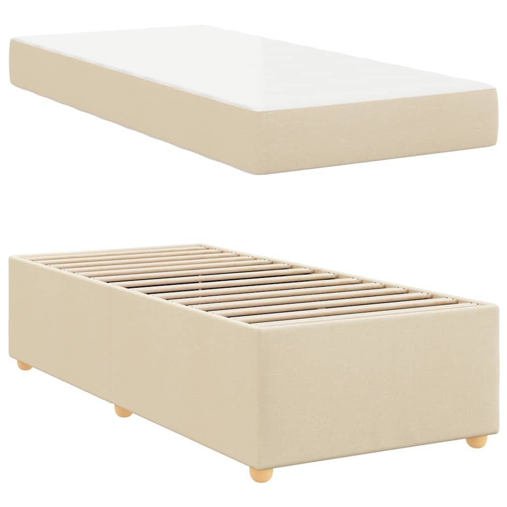 Eine beige gepolsterte Bettbasis mit Holzbeinen wird aus zwei Perspektiven gezeigt: einmal mit einer weißen Matratze darauf und einmal mit sichtbarer Lattenunterstützung.