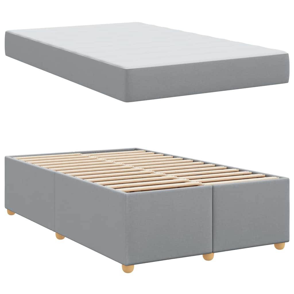 Graue Boxspringbett- und Matratzengarnitur mit Holzbeinen. Die Matratze wirkt bequem und robust, konzipiert für den Schlafzimmergebrauch.