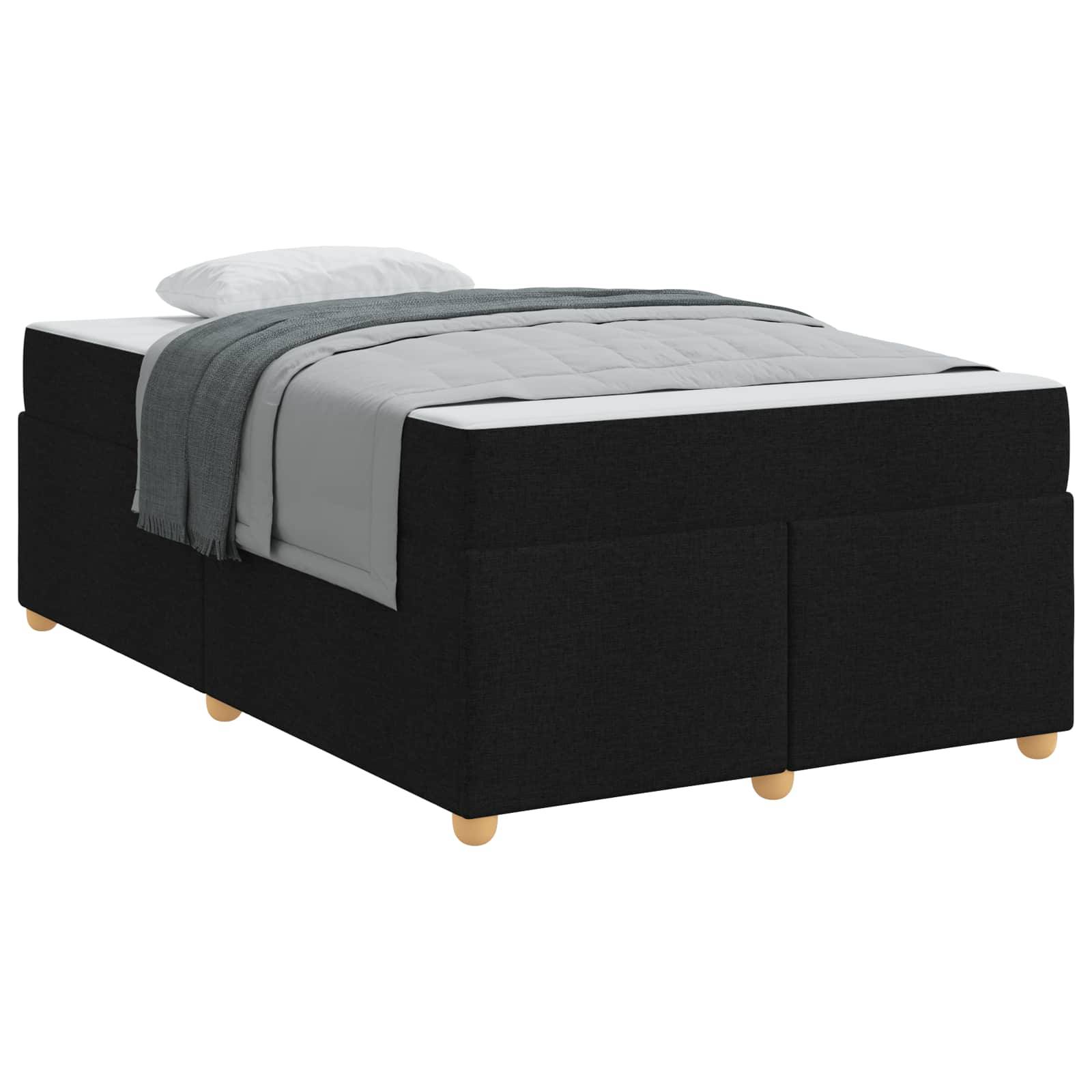 Ein schwarzes Bett mit hellen Holzbeinen, grauer Bettwäsche und einem weißen Kissen. Das Bett wirkt gut gemacht und stilvoll, passend für ein modernes Schlafzimmer.