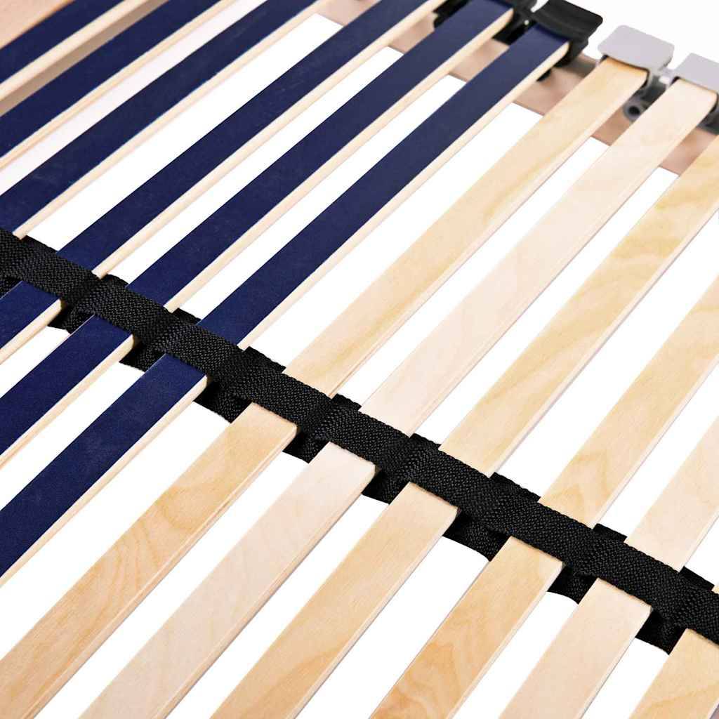 Nahaufnahme von Holzbettlatten in Marineblau und hellem Holzton, die durch schwarze Gurte zusammengehalten werden und einen Teil einer Bettrahmenstruktur bilden.