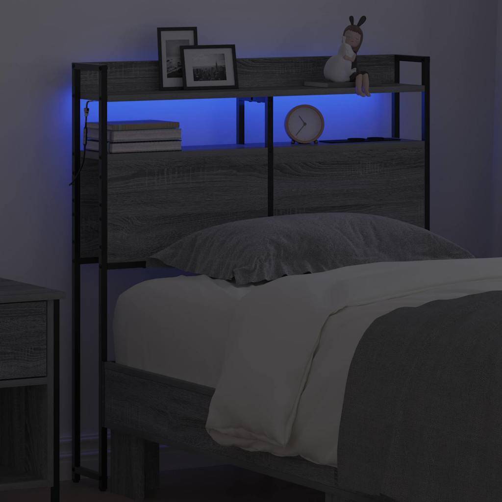 Ein Schlafzimmer mit einem Holz-Bettkopfteil, das mit blauer LED-Beleuchtung ausgestattet ist, und einem Regal mit Dekorationselementen. Ein bezogenes Bett befindet sich im Vordergrund.