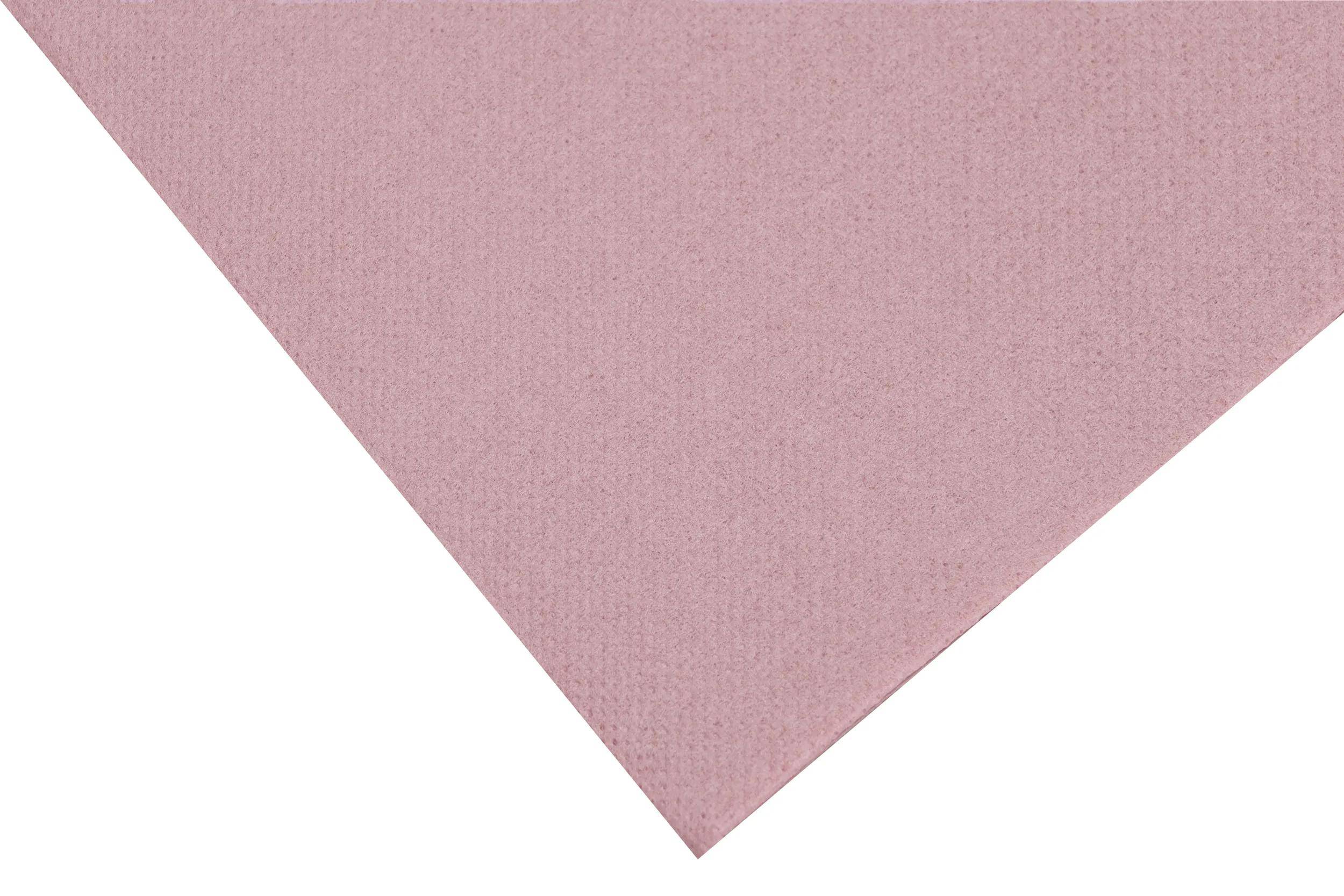 „Eine Ecke eines rosa strukturierten Papierblattes auf weißem Hintergrund.