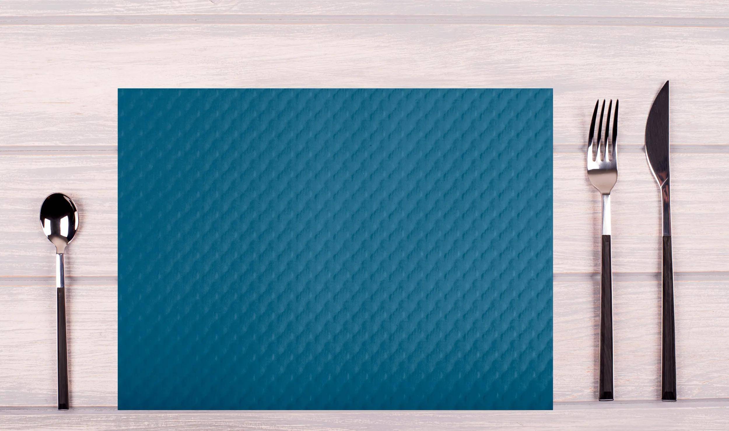 Eine blaue strukturierte Matte auf einer hellen Holzoberfläche.