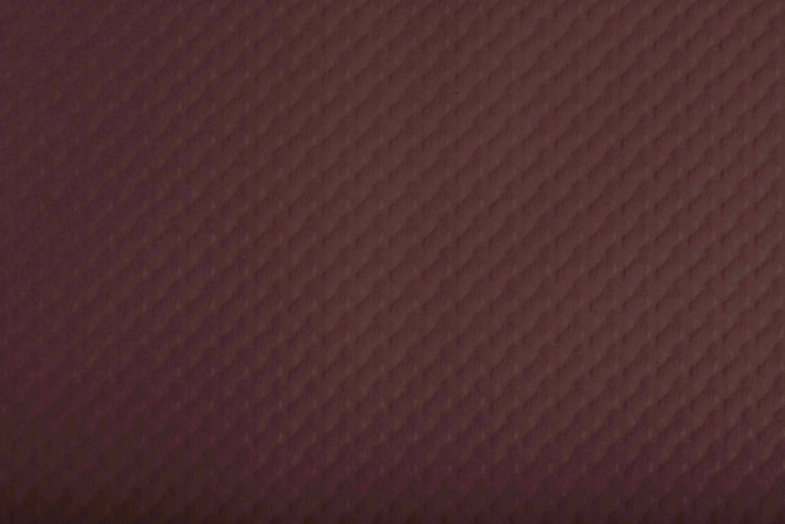 Eine Nahaufnahme einer strukturierten, dunkelroten Oberfläche mit einem diagonalen Gittermuster.