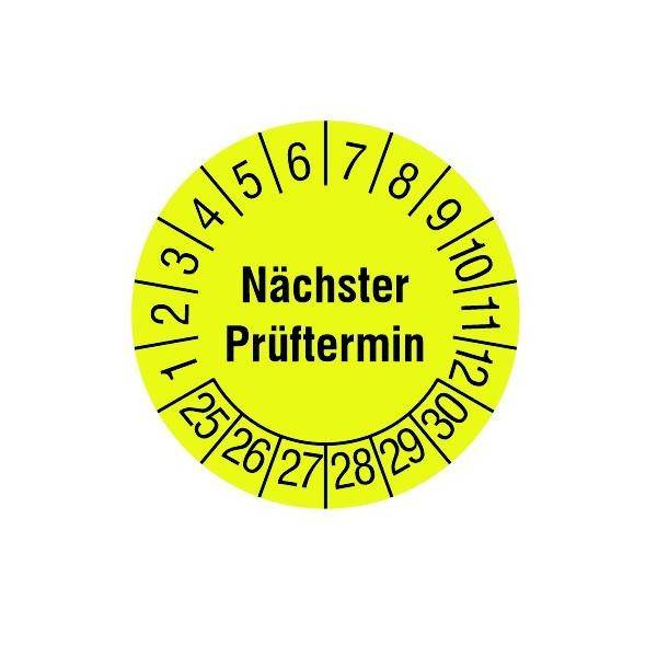 Ein gelber kreisförmiger Fahrzeug-Prüfaufkleber mit den Zahlen 1-12 am Rand und dem Wort 'Nächster Prüftermin' in der Mitte, der den nächsten Prüfungstermin anzeigt.
