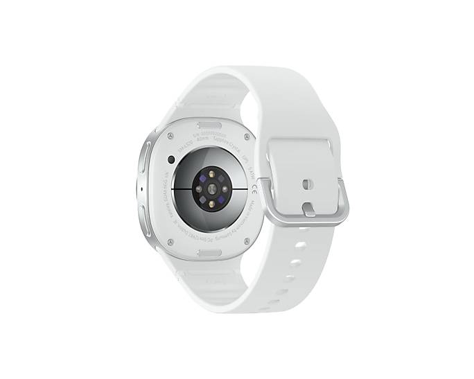 Rückansicht einer weißen runden Smartwatch mit Silikonarmband, die das Sensorarray und die Ladekontakte zeigt.