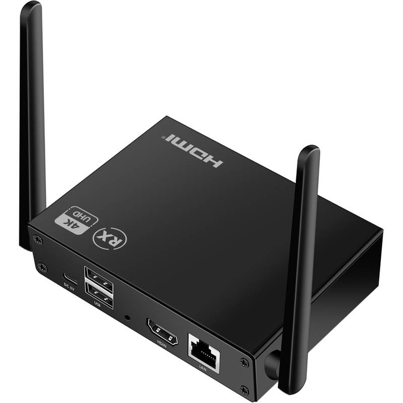 Ein kleines schwarzes elektronisches Gerät mit zwei Antennen, versehen mit HDMI-, USB- und Ethernet-Anschlüssen und gekennzeichnet mit '4K UHD' und 'RX'.