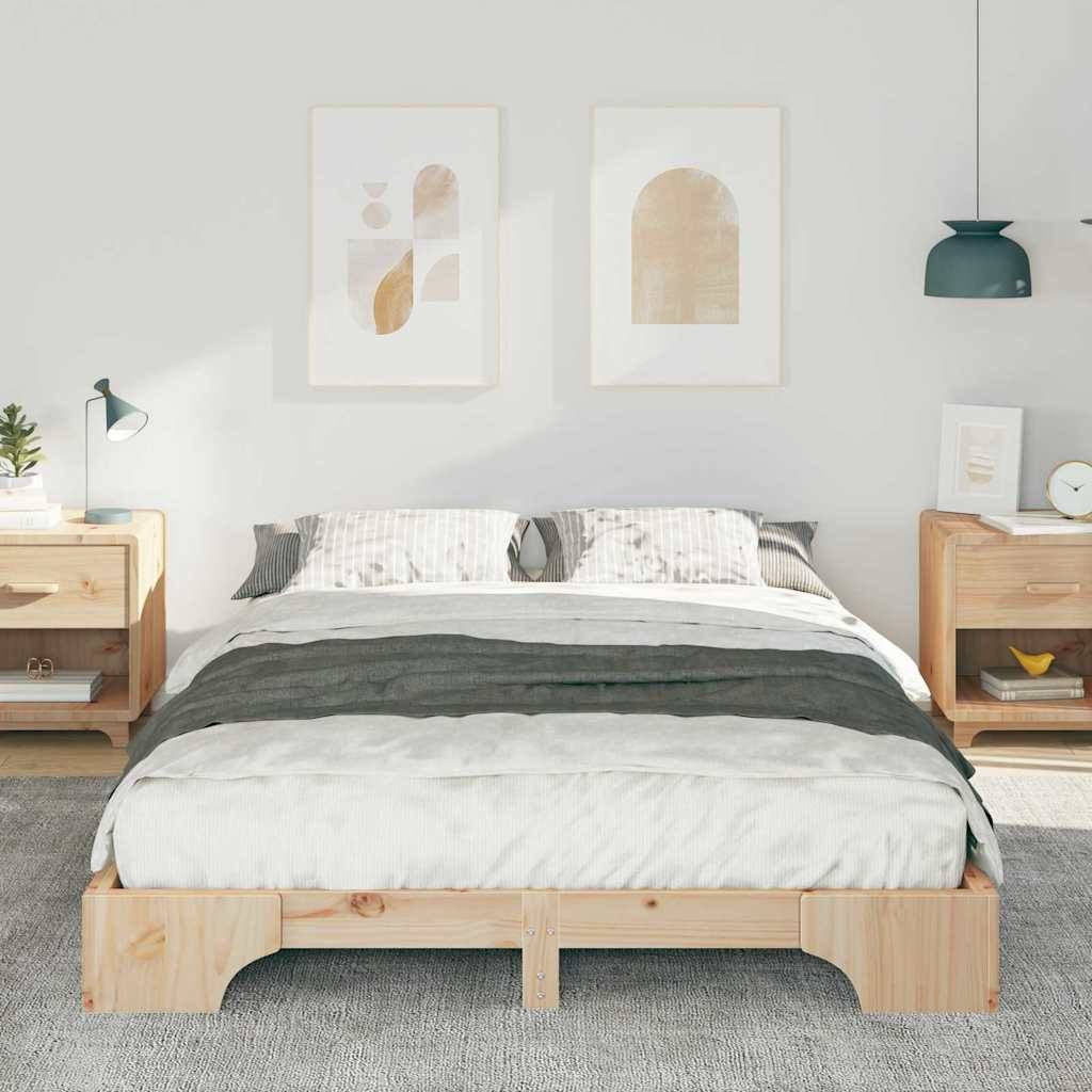 Ein modernes Schlafzimmer zeigt ein Holzbett mit weiß-grauer Bettwäsche, flankiert von zwei hölzernen Nachttischen. Kunstwerke hängen über dem Bett.