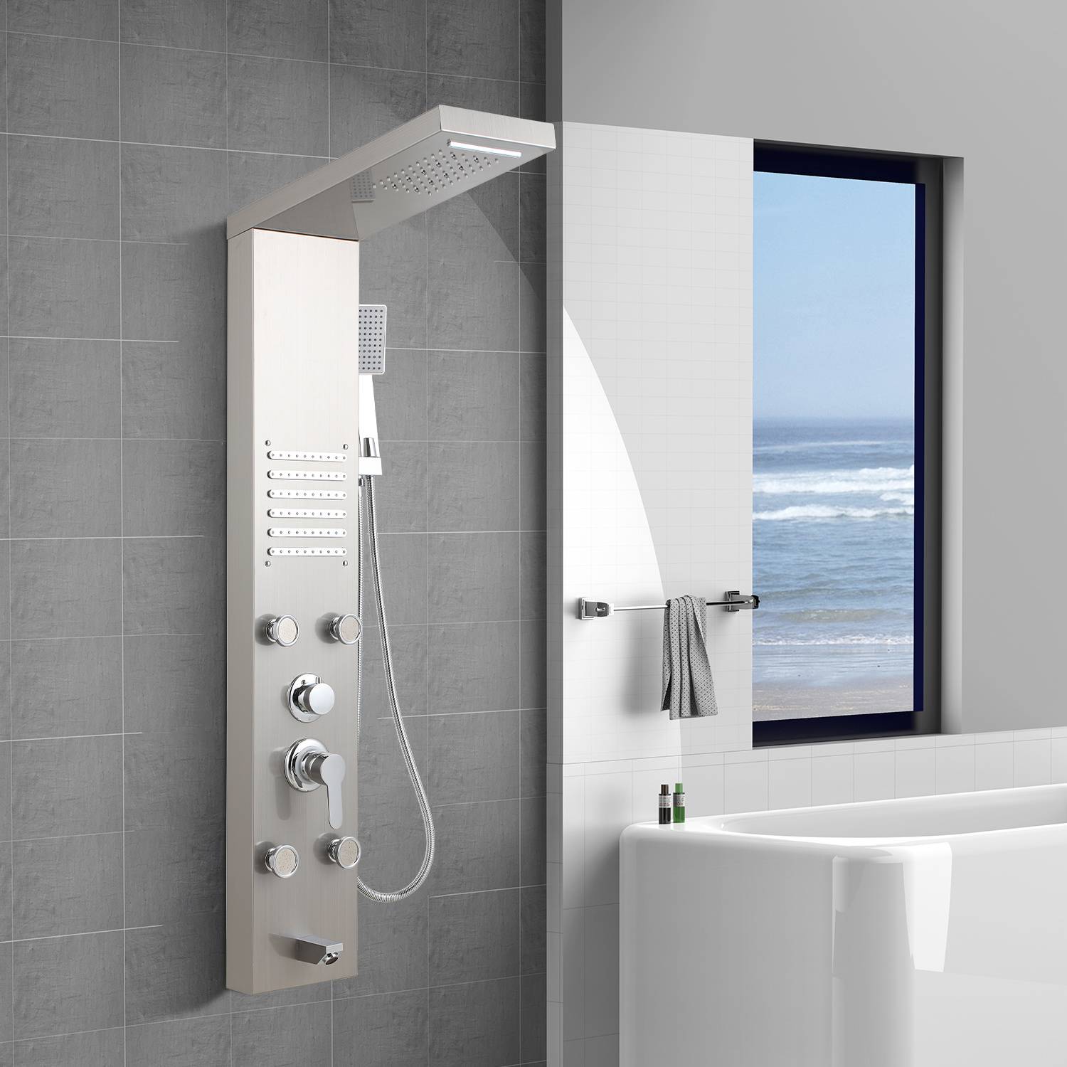 Modernes Duschpaneel mit Regenduschkopf und Handbrause neben einer Badewanne, mit Meeresblick durch das Fenster.