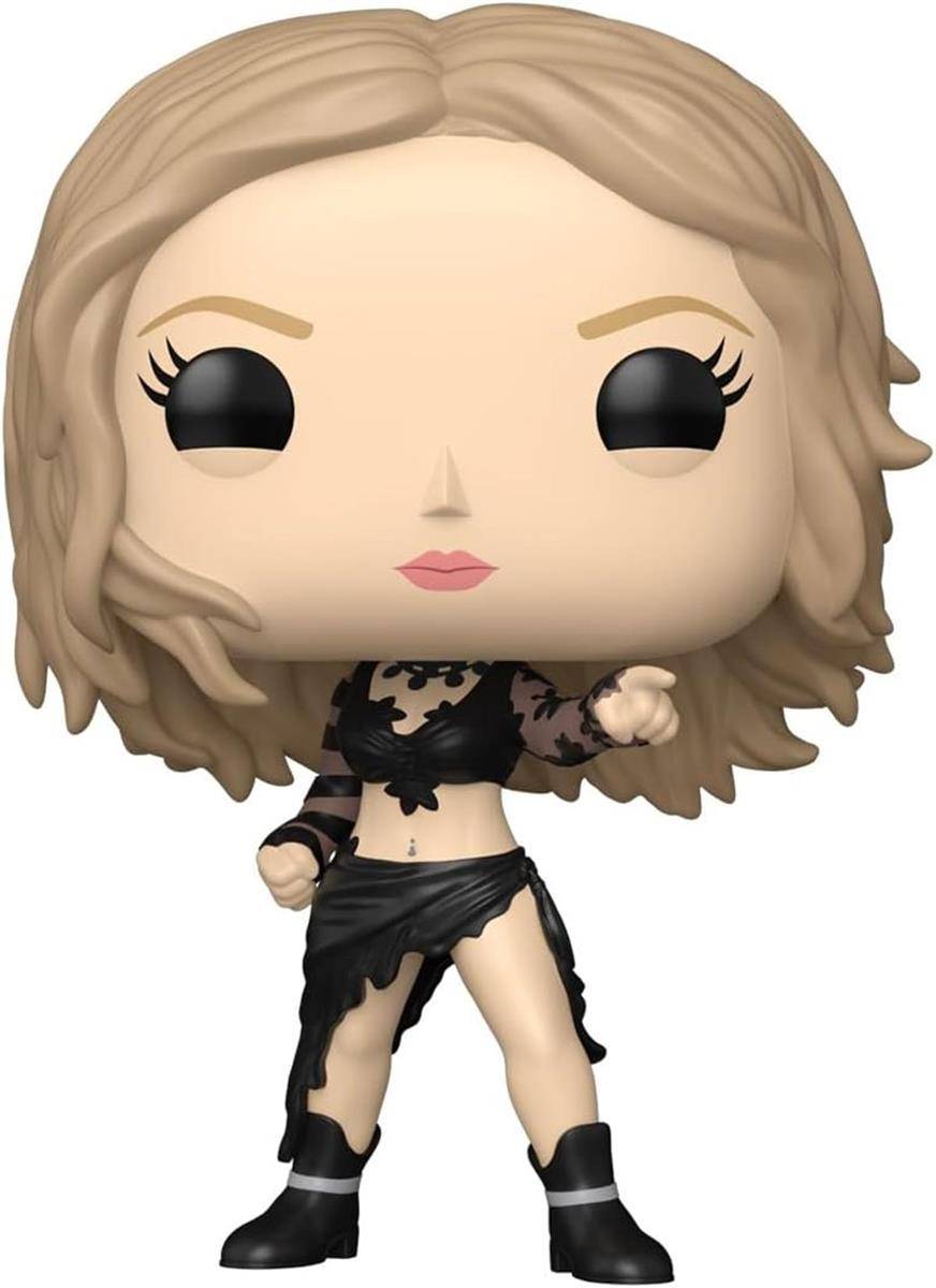 Eine stilisierte Vinyl-Figur einer blonden Frau in schwarzem Outfit, die mit erhobener Faust vor einem einfachen weißen Hintergrund steht.