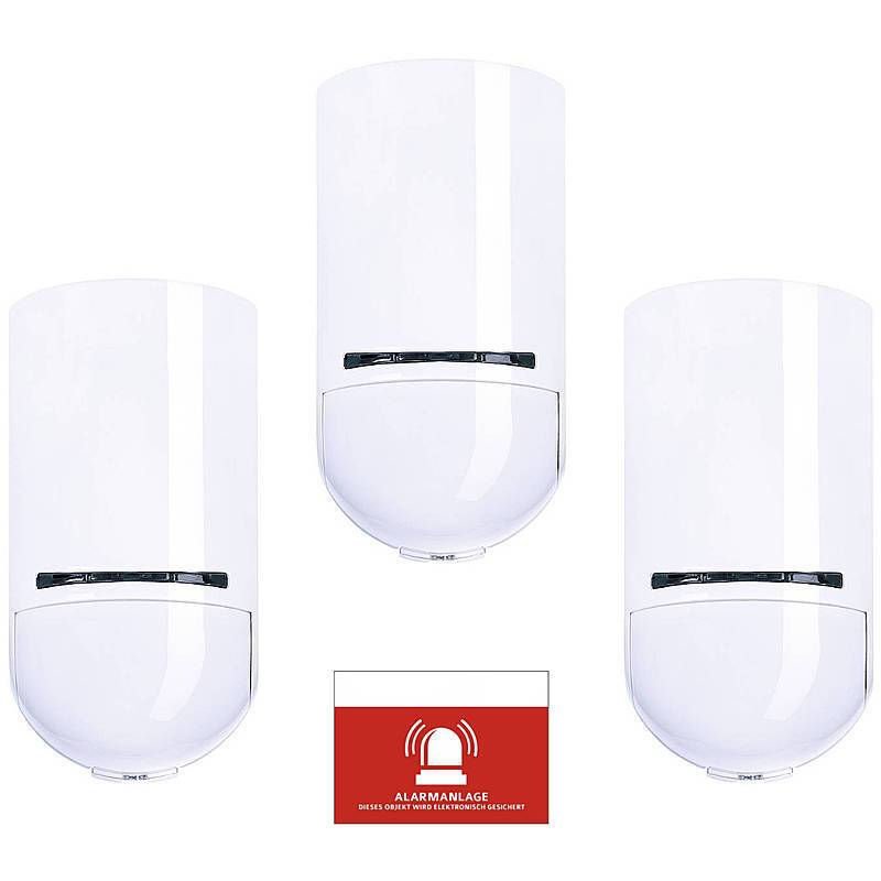 Drei weiße Sicherheitssensoren sind über einem Warnschild angebracht, das 