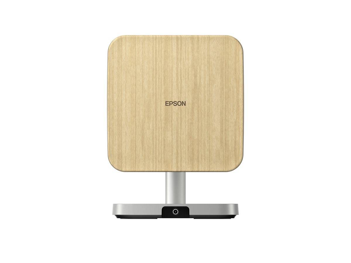 Ein kompakter, quadratischer Epson-Projektor mit einer Oberfläche in heller Holzoptik und einer kreisförmigen Basis, entwickelt für moderne Wohn- und Büroräume.