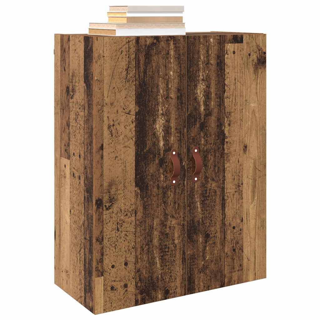 Ein rustikaler Holzschrank mit zwei Türen und Ledergriffe hat einen Stapel Bücher obenauf.