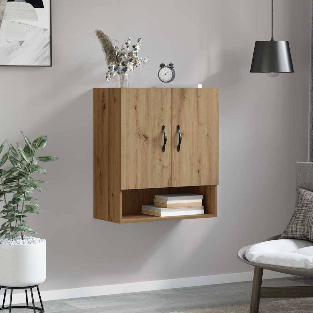 Ein Holz-Wandschrank mit zwei Türen und einem unteren Regalfach, über einer Pflanze positioniert und neben einem runden Tisch mit einem Kissen.