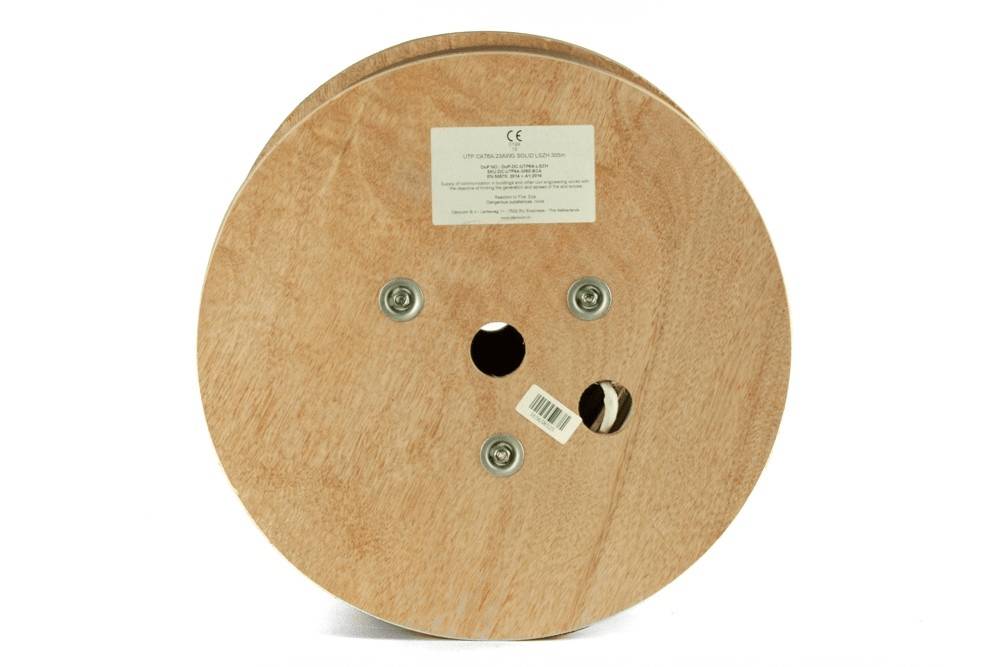 Eine hölzerne Kabelspule, die flach liegt, mit Barcode und Etikett mit Spezifikationen oben angebracht.