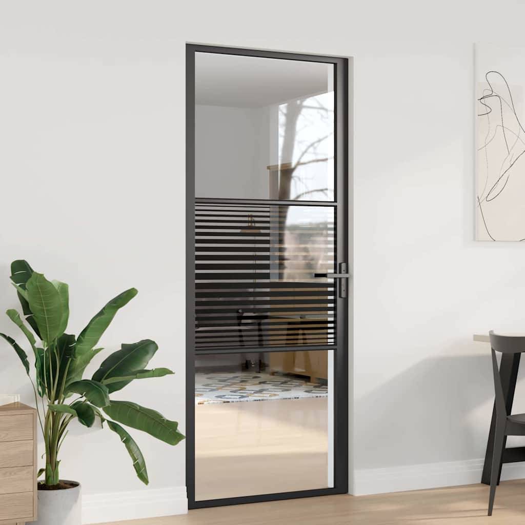 Eine moderne Glastür mit horizontalen schwarzen Streifen, die einen Baum und das Rauminterieur reflektiert. In der Nähe befinden sich eine Topfpflanze und minimalistische Einrichtungsgegenstände.