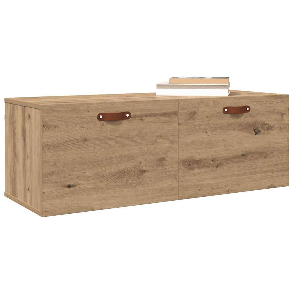 Holzwandschrank mit zwei Türen mit Ledergriffe; drei Bücher sind auf der Oberseite platziert.