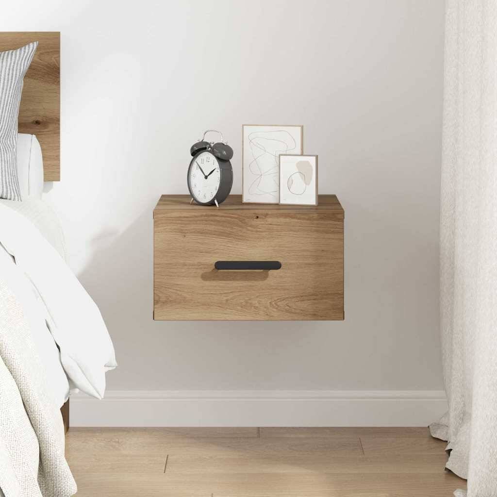 Eine moderne Schlafzimmer-Szenerie mit einem schwebenden Holznachttisch, einem Wecker und gerahmter Kunst. Ein weißes Bett ist teilweise sichtbar.