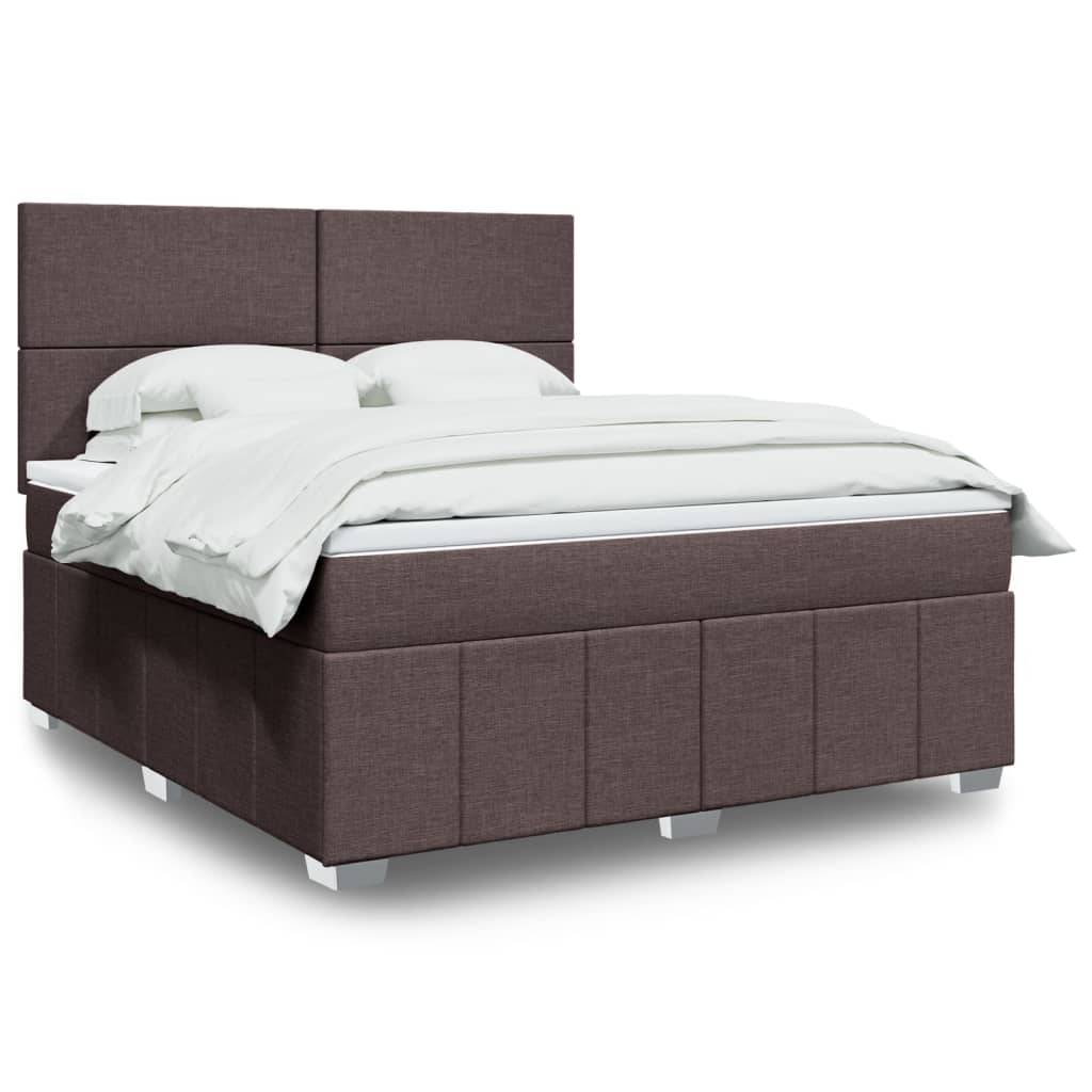 Ein modernes braunes gepolstertes Bett mit hohem Kopfteil, weißen Kissen und einer weißen Bettdecke, auf kurzen quadratischen Beinen stehend.