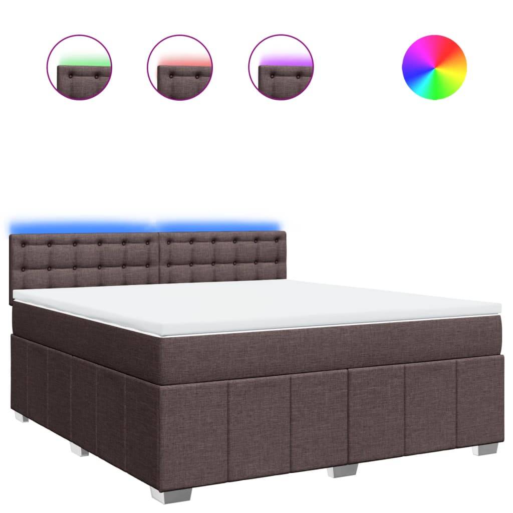 Ein Bett mit dunkler Polsterung, einer weißen Matratze und einem LED-beleuchteten Kopfteil mit wählbaren Farben, dargestellt durch Farbkreise darüber.