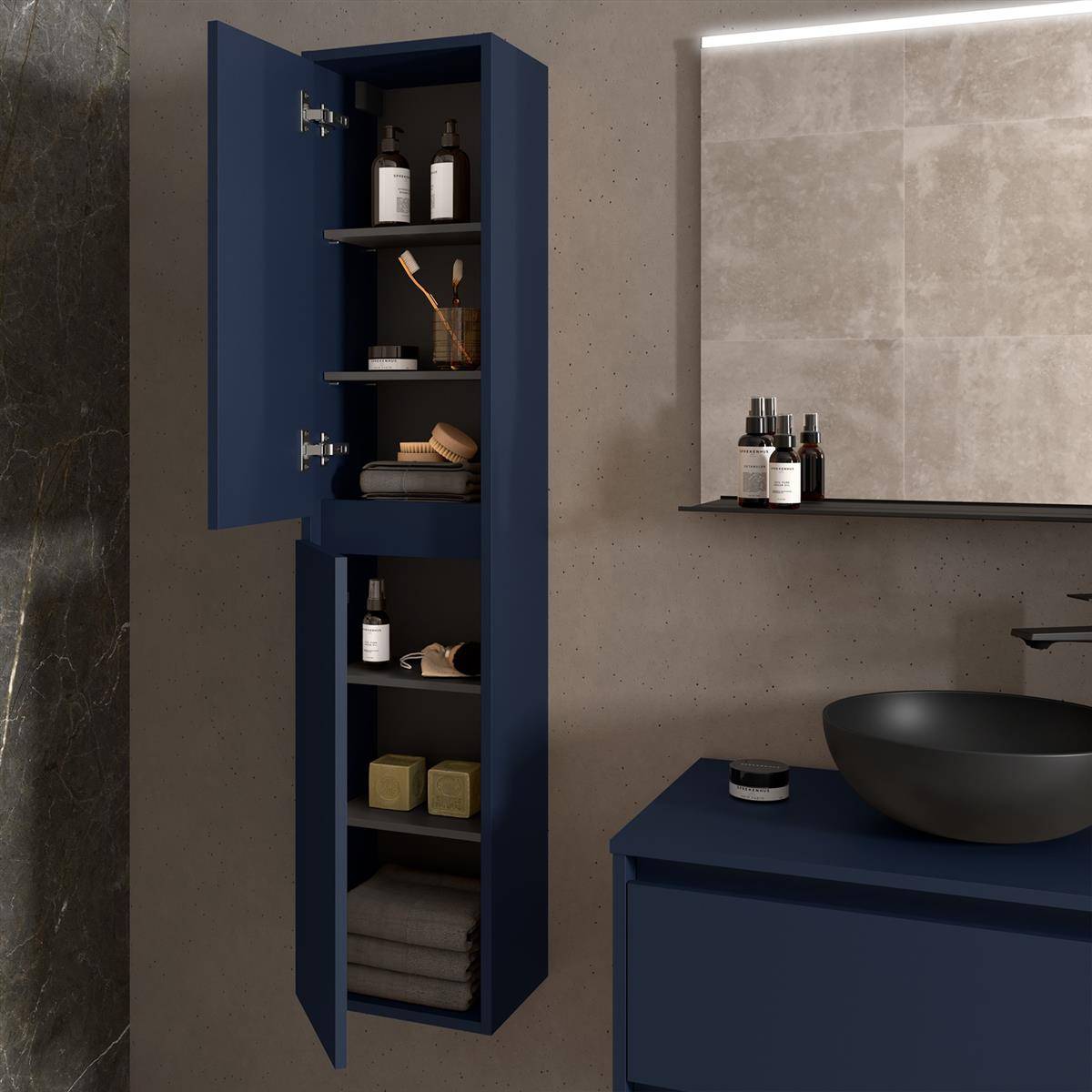 Modernes Badezimmer mit dunkelblauem Wandschrank und Waschtisch, schwarzem Aufsatzwaschbecken, Spiegelablage und Toilettenartikeln vor einer Wand mit Steinfliesen und Beton.