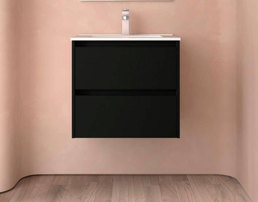Schwarzes, wandmontiertes Badezimmer-Waschtisch mit weißer Arbeitsplatte und integriertem Waschbecken an einer rosa Wand und Holzboden.